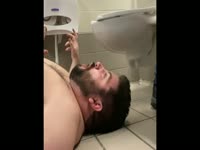 BEING FED IN A PUBLIC TOILET